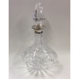 A silver and cut glass decanter together with stop
