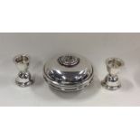 A circular silver travelling candlestick in domed