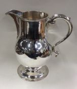 A massive George II silver beer jug on sweeping pedestal