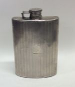 A large silver engine turned hip flask with hinged