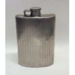 A large silver engine turned hip flask with hinged