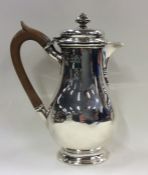 An Edwardian silver hinged top water jug on oval p