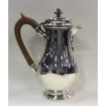 An Edwardian silver hinged top water jug on oval p