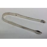 A good pair of Georgian silver bright cut tongs. L