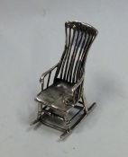 A novelty silver doll's house rocking chair. Appro