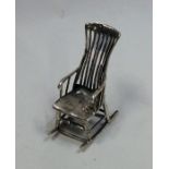 A novelty silver doll's house rocking chair. Appro