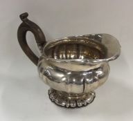 A Continental silver squat cream jug on spreading