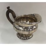 A Continental silver squat cream jug on spreading