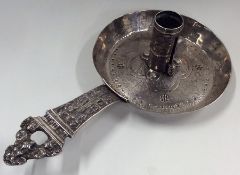 An unusual circular silver chamber stick attractiv