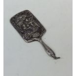 A miniature silver handbag mirror embossed with fi
