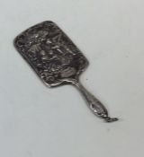 A miniature silver handbag mirror embossed with fi