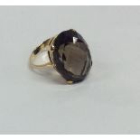 A brown topaz single stone ring in 9 carat claw mo