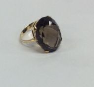 A brown topaz single stone ring in 9 carat claw mo