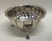 A Georgian Irish silver sugar bowl on three scroll