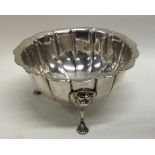 A Georgian Irish silver sugar bowl on three scroll