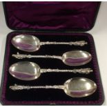 A cased set of four silver apostle top spoons with