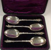 A cased set of four silver apostle top spoons with