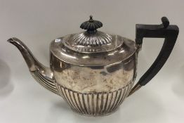 An Edwardian half fluted silver teapot. Sheffield.