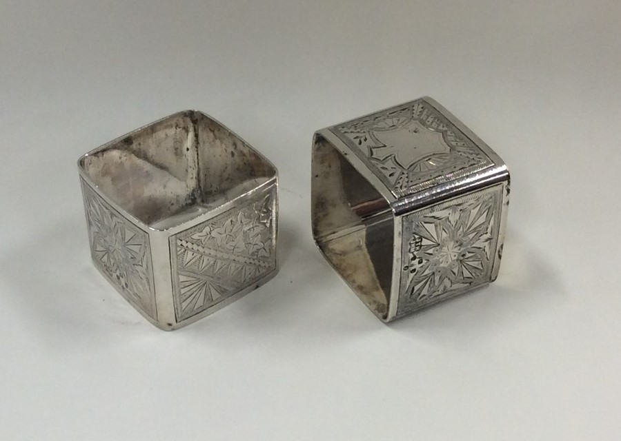 A pair of Victorian silver napkin rings decorated - Image 2 of 2
