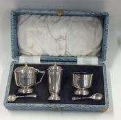 A good boxed three piece silver cruet set. Birming