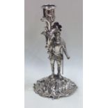 An unusual silver candlestick in the form of a war