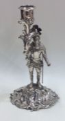 An unusual silver candlestick in the form of a war