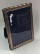 A modern rectangular silver picture frame with ree