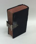An Antique silver mounted bible with leather top.