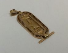 A heavy high carat gold pendant of Egyptian design