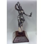 A tall figure of a lady in robes on mahogany base.