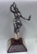 A tall figure of a lady in robes on mahogany base.