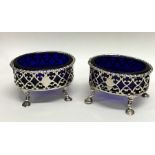 A pair of Georgian silver oval salts with pierced