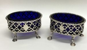 A pair of Georgian silver oval salts with pierced