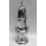 A massive hexagonal silver sugar caster on spreadi