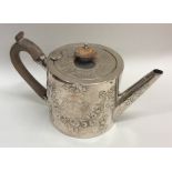 An unusual circular silver Georgian teapot decorat