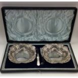 A pair of heavy silver sweet dishes decorated with