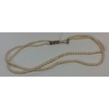 A good double string of pearl beads with 9 carat c
