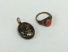 An oval gold and enamel locket together with an at