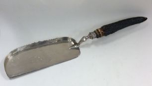 A silver crumb scoop with horn handle. Sheffield.