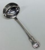 A silver hourglass pattern cream ladle. London. By