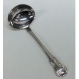 A silver hourglass pattern cream ladle. London. By