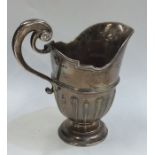 A heavy Victorian silver cream jug on spreading su