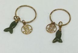 A pair of Chinese gold and jade earrings with carv