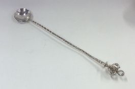 A silver tobacco spoon with crown finial to twiste