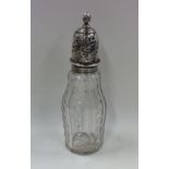 A Georgian silver mounted glass sugar caster. Appr