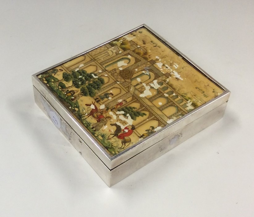 A rectangular ivory and silver cigarette box with