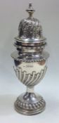 A massive Victorian silver half fluted sugar caste