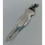 A small novelty silver bookmark decorated with a f
