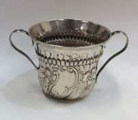 A silver George I half fluted porringer with reede