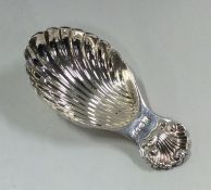 A silver caddy spoon with fluted bowl and shell th